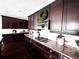 Well-appointed kitchen featuring dark cabinetry, granite countertops, and stainless steel gas range at 15468 W 50Th Pl, Golden, CO 80403