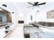 Bright living room with stacked stone fireplace and large sectional sofa for comfortable seating at 15468 W 50Th Pl, Golden, CO 80403