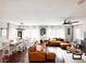 Open-concept living and dining area with hardwood floors and ample natural light creates a cozy atmosphere at 15468 W 50Th Pl, Golden, CO 80403