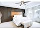 Serene main bedroom with a stylish accent wall, plush bedding, and lots of natural light at 15468 W 50Th Pl, Golden, CO 80403
