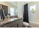 Bright bathroom with granite countertops, dark accents and stylish finishes at 11830 W 52Nd Ave, Wheat Ridge, CO 80033