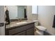 Bathroom features vanity with a granite countertop, tile floors and modern fixtures at 11830 W 52Nd Ave, Wheat Ridge, CO 80033