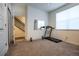 Bedroom with stairs and door leading to bathroom. Neutral carpet and natural light at 11830 W 52Nd Ave, Wheat Ridge, CO 80033