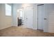 Bedroom with neutral carpet and natural light, leading to ensuite bathroom at 11830 W 52Nd Ave, Wheat Ridge, CO 80033