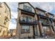 Contemporary two-story home boasts a private balcony, stone accents, and a welcoming entrance at 11830 W 52Nd Ave, Wheat Ridge, CO 80033