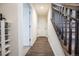 Hallway with hardwood floors, staircase, and white paneled doors create a welcoming ambiance at 11830 W 52Nd Ave, Wheat Ridge, CO 80033