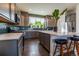 Stylish kitchen with gray cabinets, subway tile backsplash, and center island with bar stool seating at 11830 W 52Nd Ave, Wheat Ridge, CO 80033