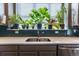 Bright kitchen window over sink provides sunlight for indoor herbs and plants at 11830 W 52Nd Ave, Wheat Ridge, CO 80033