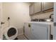 Efficient laundry room with a side-by-side washer and dryer and plenty of cabinet space at 11830 W 52Nd Ave, Wheat Ridge, CO 80033