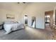 Spacious main bedroom suite featuring a king bed, a large window, and neutral decor at 11830 W 52Nd Ave, Wheat Ridge, CO 80033