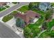 Aerial view of home featuring a brown roof, mature landscaping and an oversized driveway at 7170 Windwood Way, Parker, CO 80134