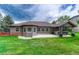 Beautiful backyard with outdoor kitchen, gazebo, green grass, and patio space at 7170 Windwood Way, Parker, CO 80134