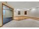 Finished basement with carpet and wood flooring, and natural light from two windows at 7170 Windwood Way, Parker, CO 80134