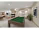 This basement boasts a kitchenette, comfortable seating, a game table, and a fireplace, creating a perfect space for relaxation at 7170 Windwood Way, Parker, CO 80134