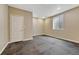 Unfinished basement space featuring a door, window and black rubber flooring at 7170 Windwood Way, Parker, CO 80134