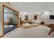This basement features a spacious rec room with a kitchenette, comfortable seating, and a game table, ideal for entertaining at 7170 Windwood Way, Parker, CO 80134