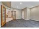 Open basement space features rubber flooring, door, and French doors leading to a carpeted area at 7170 Windwood Way, Parker, CO 80134