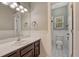 Bathroom with vanity, sink, and white wainscoting leading to a separate toilet and shower room at 7170 Windwood Way, Parker, CO 80134