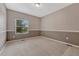 Simple bedroom with neutral walls, carpeted floor, and a window providing natural light at 7170 Windwood Way, Parker, CO 80134