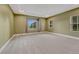 Spacious bedroom with tray ceiling, multiple windows and neutral carpeting, offering a serene retreat at 7170 Windwood Way, Parker, CO 80134