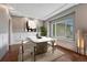 Elegant dining room with wainscotting, a modern light fixture and a large window at 7170 Windwood Way, Parker, CO 80134