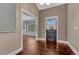 View of the entryway with hardwood floors, a windowed door, and white trim details at 7170 Windwood Way, Parker, CO 80134