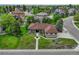 Beautifully landscaped gray house with a well-manicured lawn and other homes in the background at 7170 Windwood Way, Parker, CO 80134