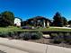 Beautifully landscaped front yard with colorful flowerbeds and a well-maintained lawn at 7170 Windwood Way, Parker, CO 80134