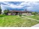 Charming home with a well-manicured front lawn and mature trees, with neutral-colored exterior at 7170 Windwood Way, Parker, CO 80134