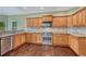 Kitchen featuring stainless steel appliances, granite counters, and wooden cabinetry at 7170 Windwood Way, Parker, CO 80134