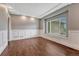 Bright living room with coffered ceiling, large window, and stylish hardwood floors at 7170 Windwood Way, Parker, CO 80134