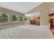Bright living room featuring vaulted ceilings and an open floor plan connected to the kitchen with bar seating at 7170 Windwood Way, Parker, CO 80134