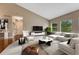 Spacious living room features a comfortable sectional sofa, modern decor, and an abundance of natural light at 7170 Windwood Way, Parker, CO 80134