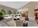Inviting living room with an open layout to the kitchen and large windows at 7170 Windwood Way, Parker, CO 80134