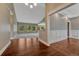 Spacious living room featuring hardwood floors, neutral walls, and ample natural light at 7170 Windwood Way, Parker, CO 80134