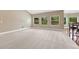 Bright living room with plush carpet, natural light, and an open layout at 7170 Windwood Way, Parker, CO 80134