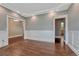 Elegant living room with decorative white trim, hardwood floors, and neutral colored walls at 7170 Windwood Way, Parker, CO 80134