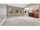 Open-concept living room with plush carpet, and seamless access to the adjacent kitchen area at 7170 Windwood Way, Parker, CO 80134