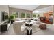 Comfortable living room with a white sectional sofa, lots of natural light, and a view into the modern kitchen at 7170 Windwood Way, Parker, CO 80134