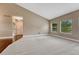 Spacious carpeted room with natural light, showcasing a versatile area for relaxation and entertainment at 7170 Windwood Way, Parker, CO 80134