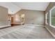 Large, open living space with neutral carpet and hardwood floors transitioning to a dining area at 7170 Windwood Way, Parker, CO 80134