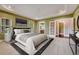 A bright main bedroom features trey ceilings, carpet floors, and an en-suite bath, creating a luxurious and comfortable space at 7170 Windwood Way, Parker, CO 80134