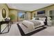 A bright main bedroom features trey ceilings, carpet floors, and natural light for a calming and airy ambiance at 7170 Windwood Way, Parker, CO 80134