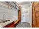 Functional mudroom with shiplap walls, built-in storage, and a utility sink at 7170 Windwood Way, Parker, CO 80134
