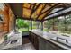 Covered outdoor kitchen featuring ample counter space, storage, and an outdoor grill at 7170 Windwood Way, Parker, CO 80134