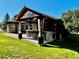 Covered outdoor kitchen with a bar and seating, perfect for entertaining at 7170 Windwood Way, Parker, CO 80134