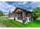 Outdoor kitchen and bar area with seating on a well-manicured lawn at 7170 Windwood Way, Parker, CO 80134