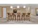 Finished basement features a stunning wet bar with seating for six and unique lighting at 7170 Windwood Way, Parker, CO 80134