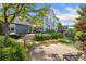 Spacious backyard with a stone patio, outdoor seating, and lush garden beds, ideal for outdoor living at 2856 Shadow Lake Rd, Lafayette, CO 80026