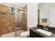 Well-maintained bathroom featuring a walk-in shower, granite countertops and a mosaic tile design at 2856 Shadow Lake Rd, Lafayette, CO 80026